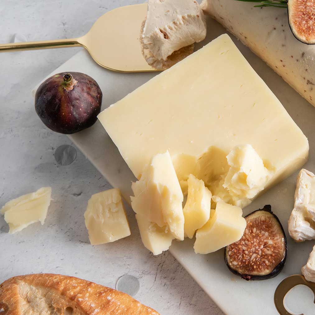 Aged extra sharp Cheddar showing the crumbly texture characteristic of long aging